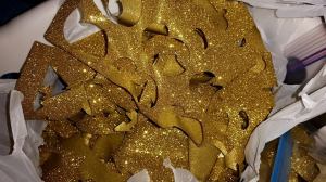 Scraps of heat press glitter left from "weeding" the designs for shirts.  It no longer has a heavy backing.  It is very flexible when hot.  You can trace onto it and cut it easily.