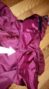 Zig zagged raw edge from cutting the front bodice apart.