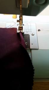 Making a simple rolled hem for the bottom of the sleeve insert.