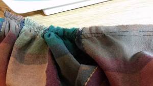 Run two gathering threads.  Use the largest running stitch your machine makes.  Pull on the bobbin thread.  Leave extra long tails.