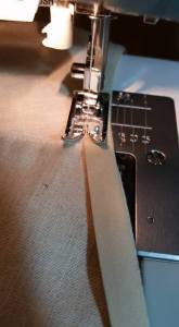 Sewing the bias tape to make a casing.