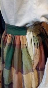 Front and back tied on . . . the waistbands should have been made longer so that the sides overlapped.