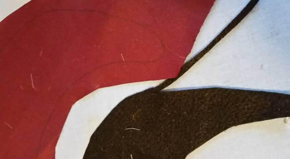 Fashion fabric traced and cut somewhat larger.  Felt backing traced and trimmed slightly smaller.