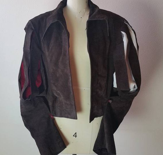 jacket shown with red undersleeve, and white shirt sleeve