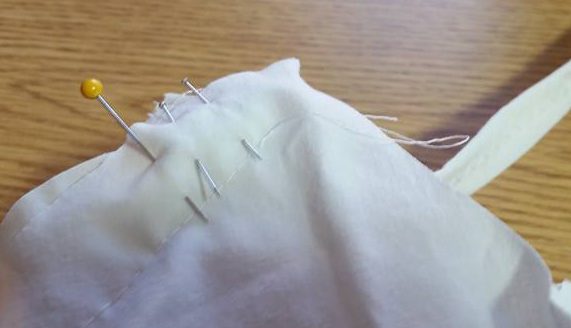 the tie is inserted into the seam for stiching