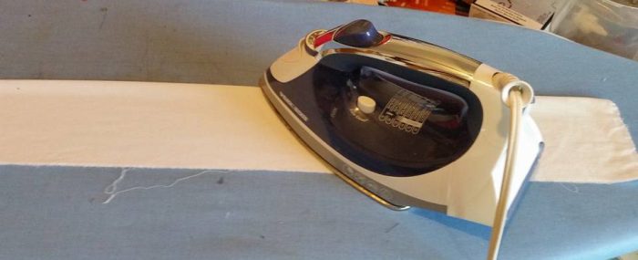 ironing in the ruffle fabric in half