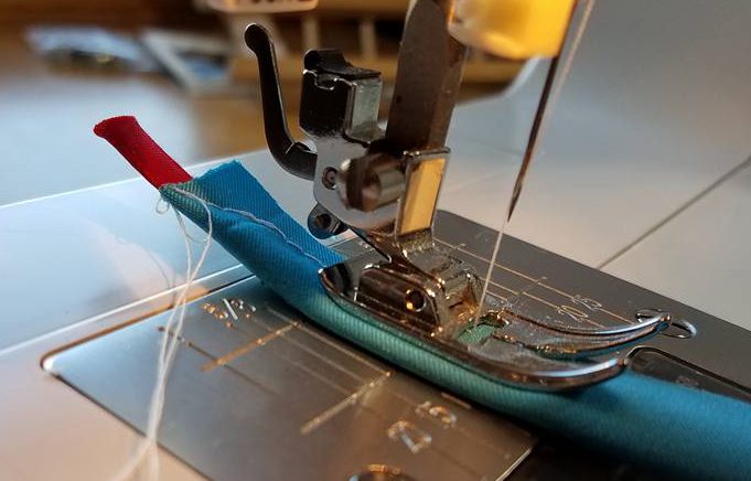 curving the end over the string for easier turning