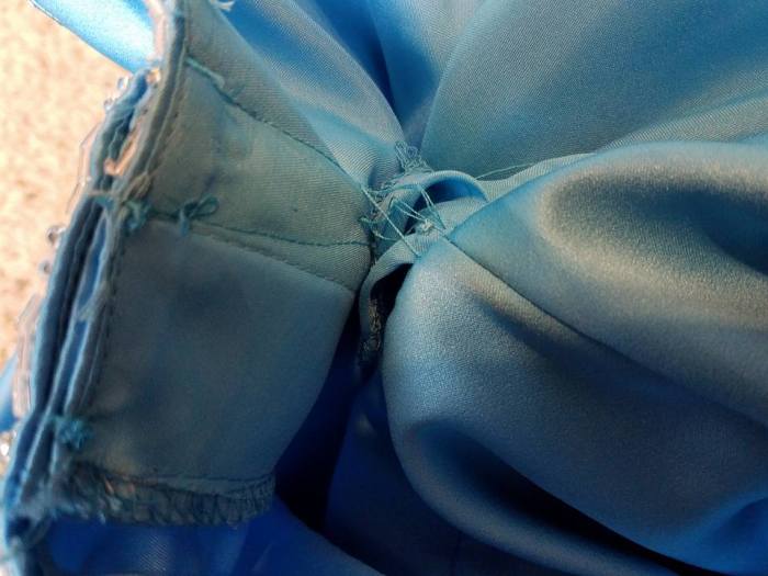 long threads connect the bodice to the skirt/lining