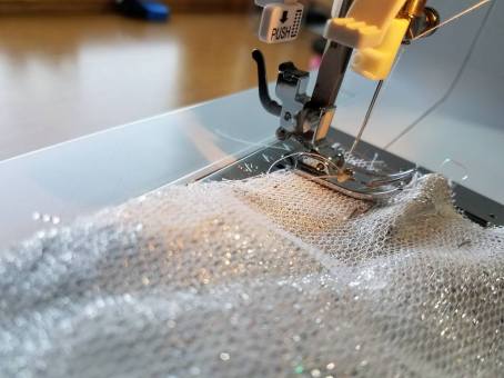 basting the petticoat net to the fashion fabric