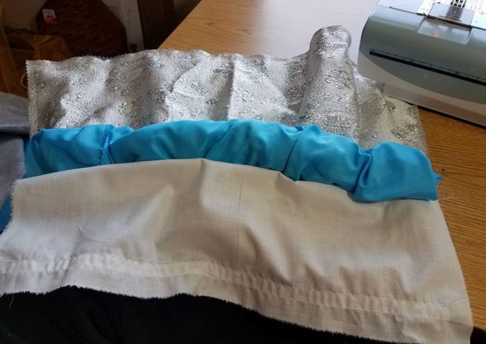 the long sleeve is rolled up to keep it from getting caught in the stiching