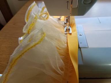 folding ribbon over to finish the edge and make casing
