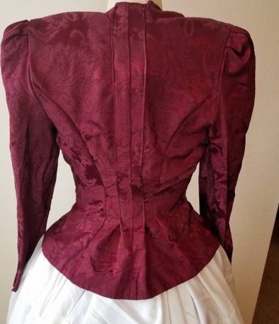 back of jacket shaped--pleat at the center back, curved seams taken in