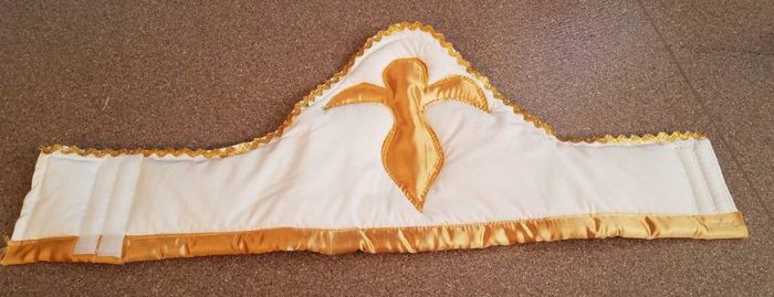 front of hat--religious figure