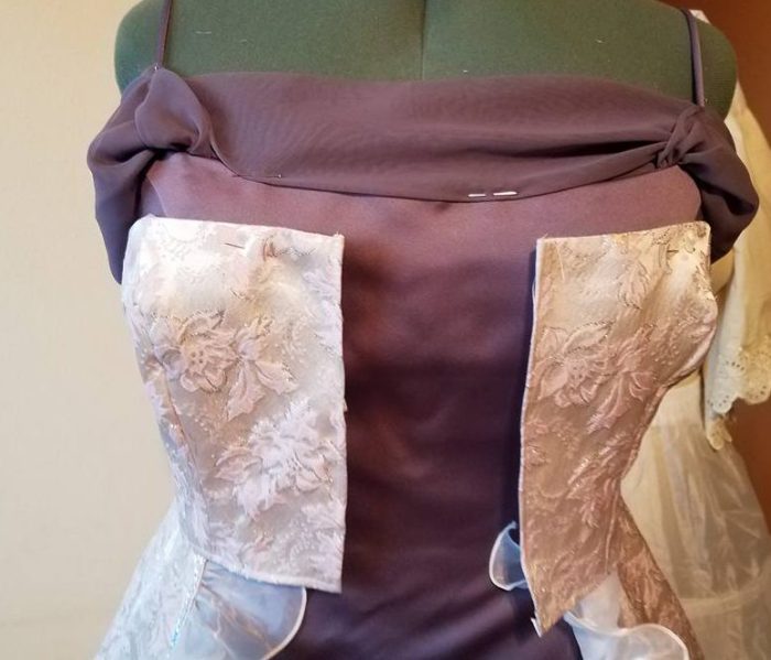 pinning the front drape up on to the straps, and the bodice to the base dress