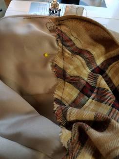 stitching the overskirt to the satin skirt along the easing thread