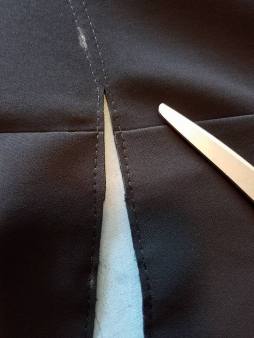 cutting between two parallel rows of stitching
