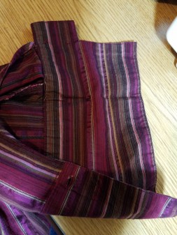 cuff folds up, getting ready to cut off the excess